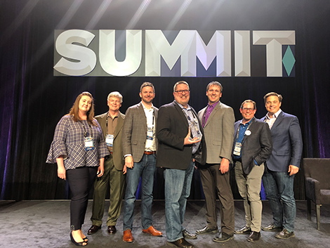 bounteous team poses on stage during adobe summit emerging partner awards