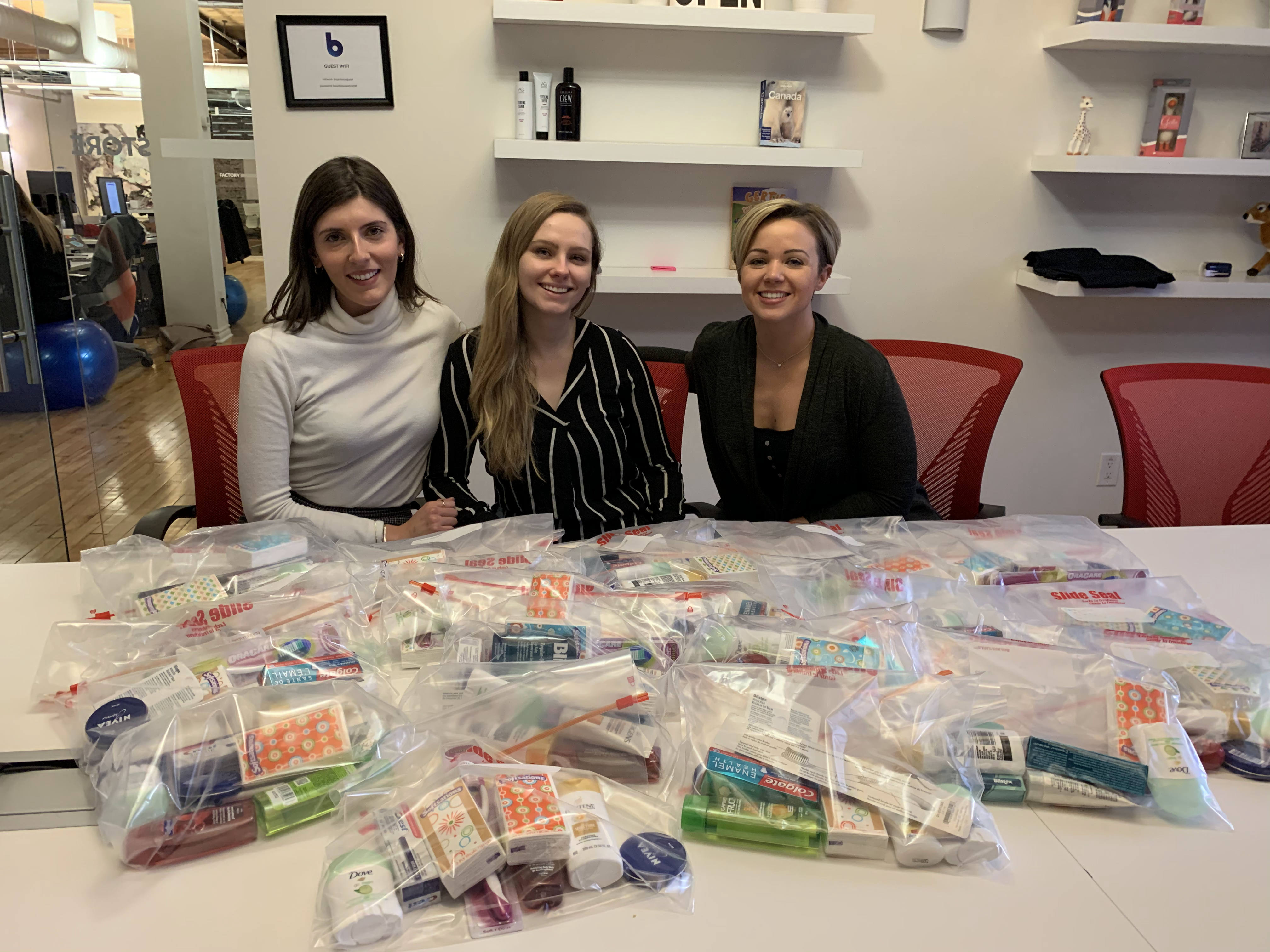bounteous team members sit in front of their blood drive care packages