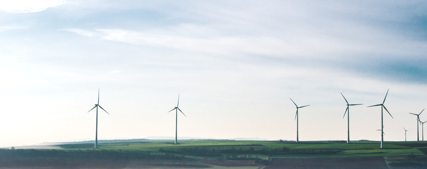 image of a wind turbines in a large grassy field