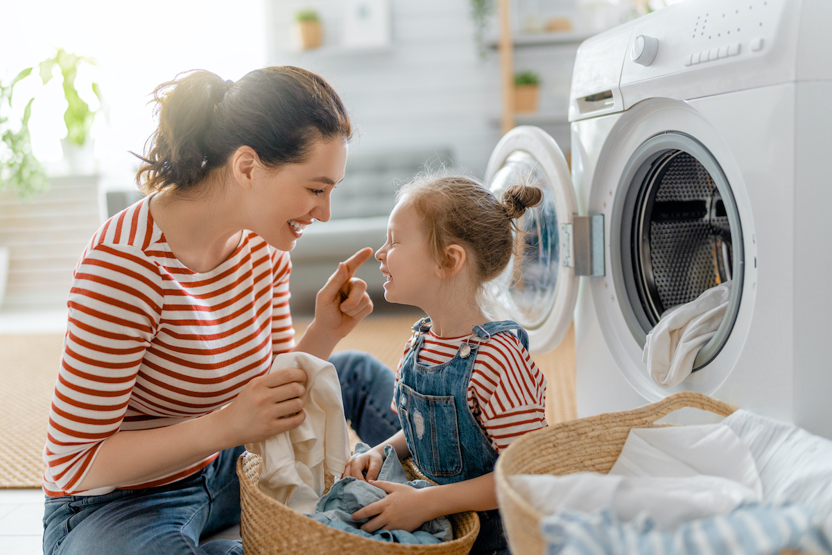 Mom and daughter doing laundry together