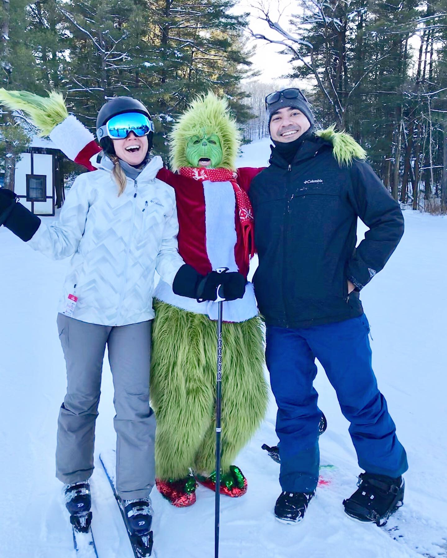 Team members skiing with the grinch