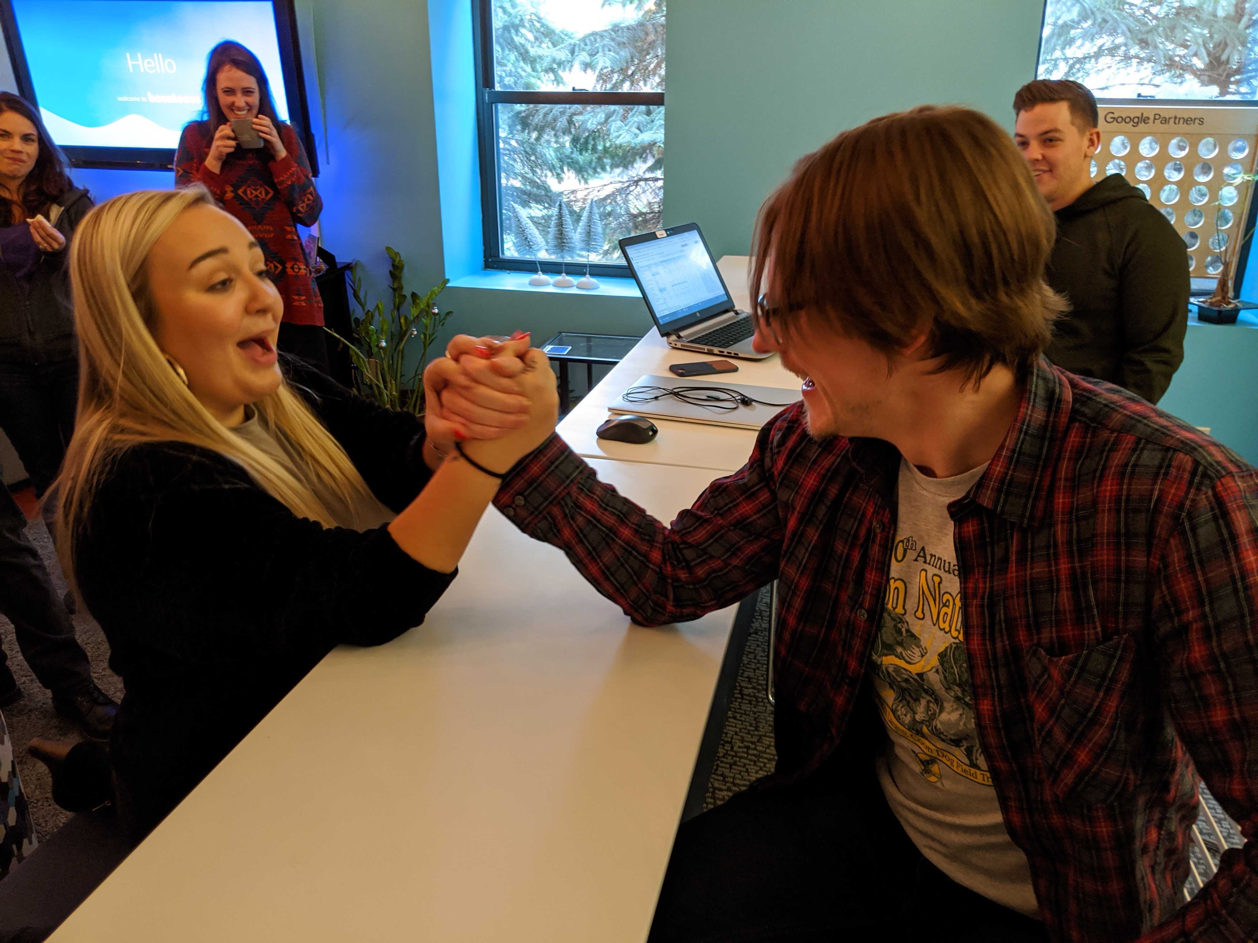 team members arm wrestling