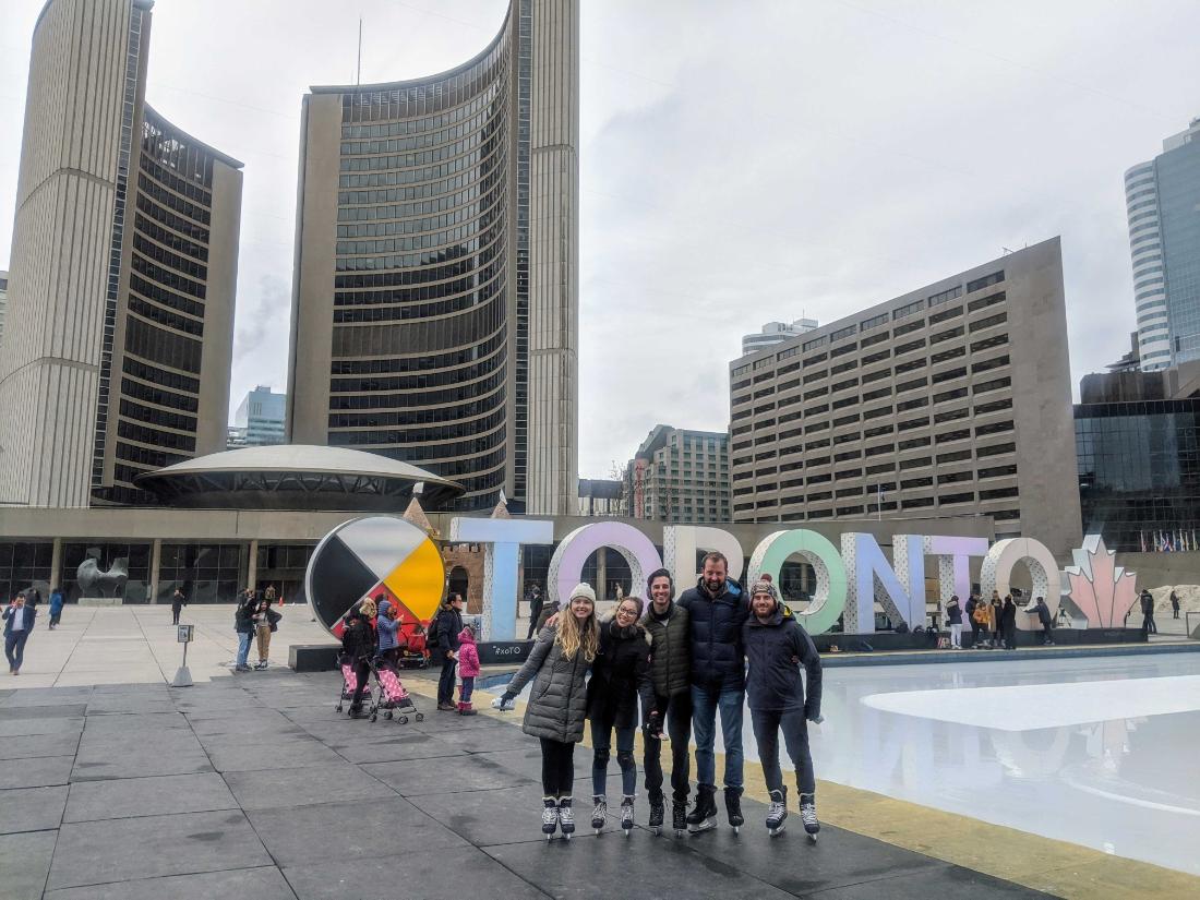 toronto sign with coworkers