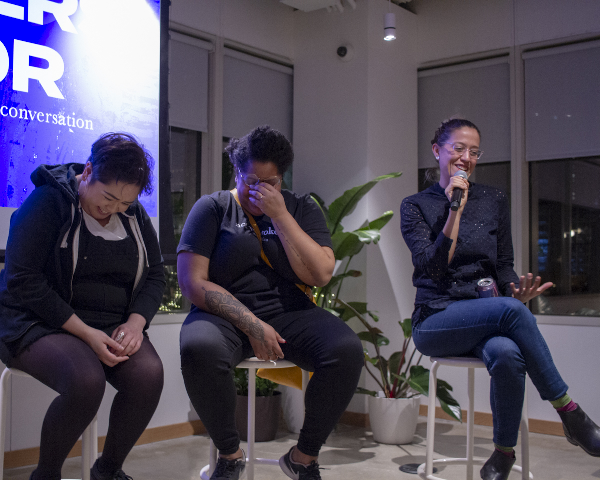 Paola Aguirre holds the mic during the Designers of Color event while addressing a moderator question