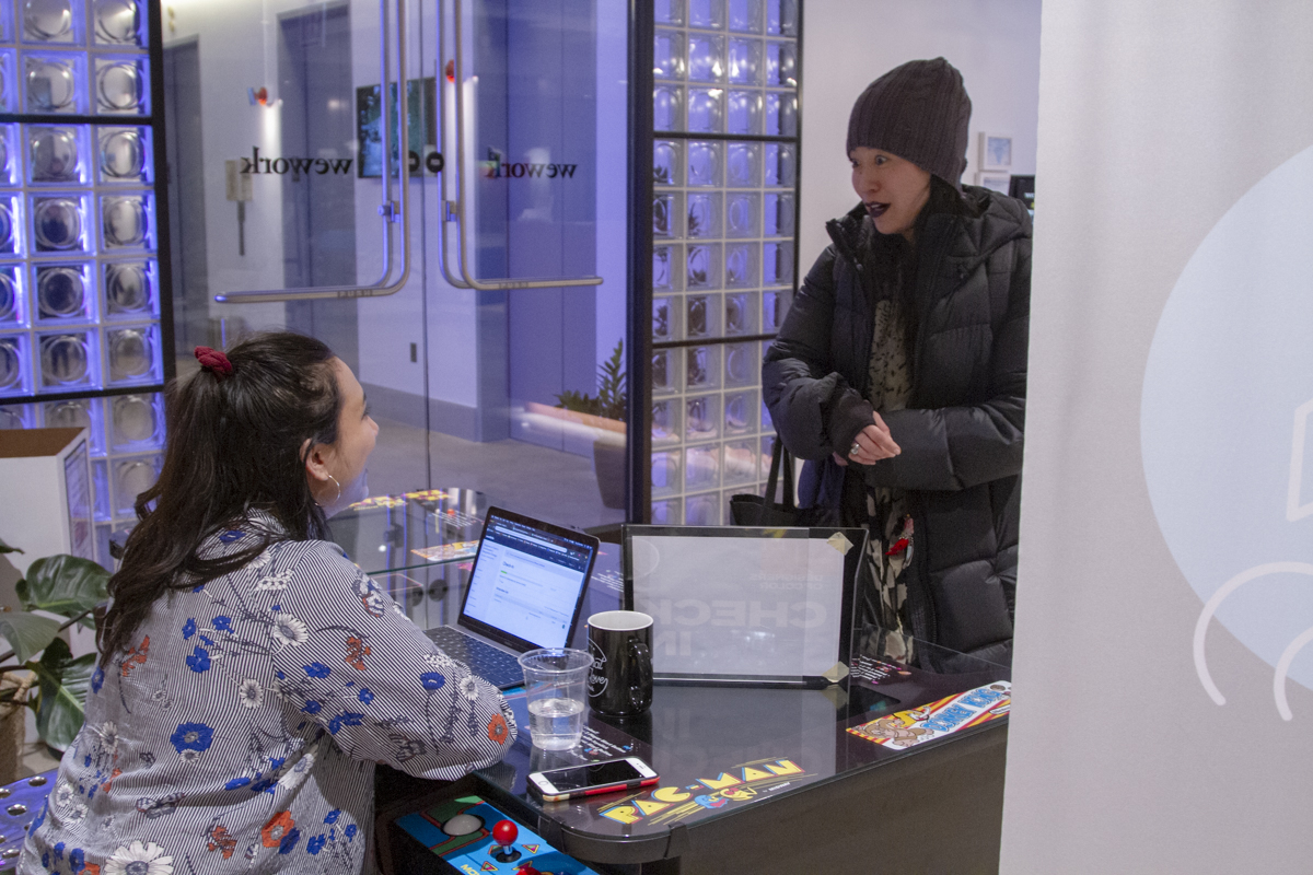 A guest checks in at the Designers of Color in conversation event, bundled up from the winter cold