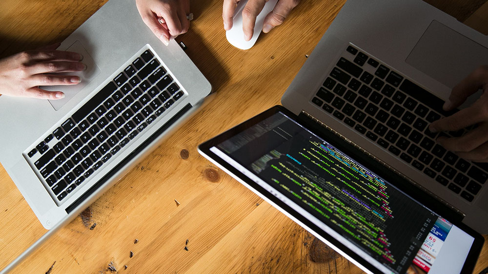 two computers next to each other on a table