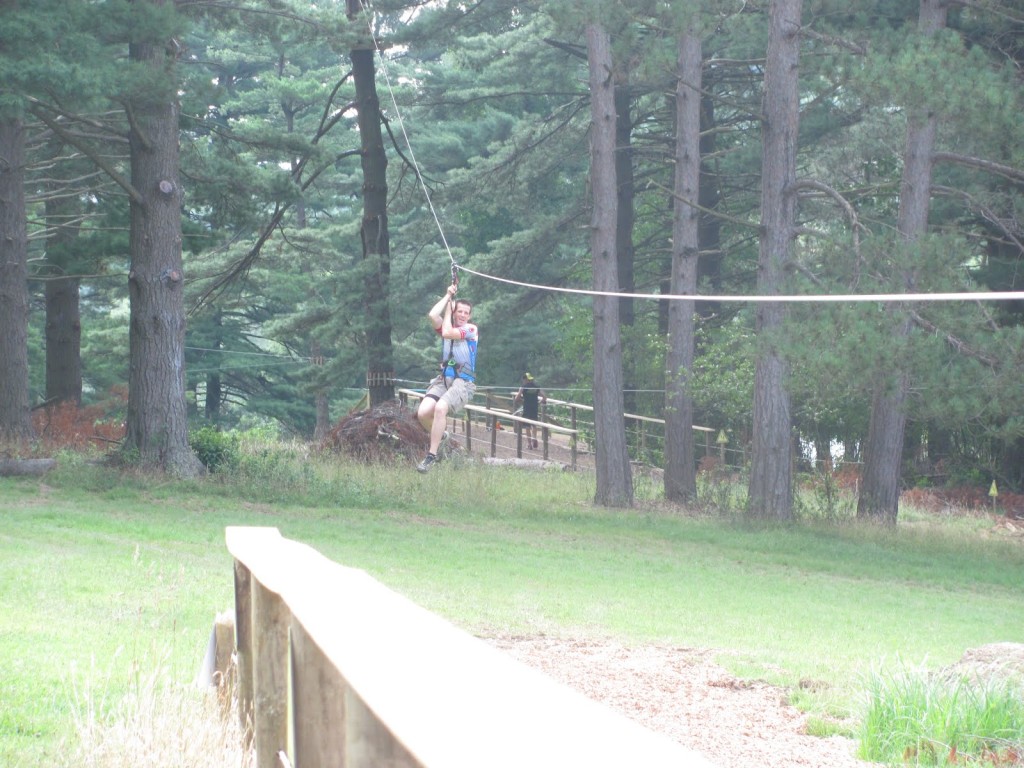 Jim Gianoglio flys down one of the giant ziplines between course obstacles